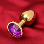 Малая металлическая золотистая анальная пробка Оки-Чпоки с фиолетовым кристаллом - 7 см